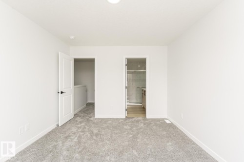 The property features light gray carpeting, white walls, and white trim - 6371 King Wynd, Edmonton, AB - Indoor Photo Showing Other Room