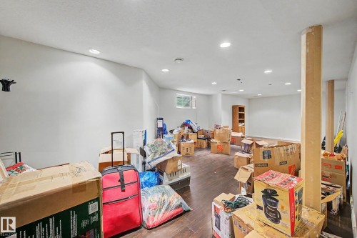 This spacious room features recessed lighting, light-colored walls, and dark flooring - 21 1850 Mill Woods Road E, Edmonton, AB - Indoor