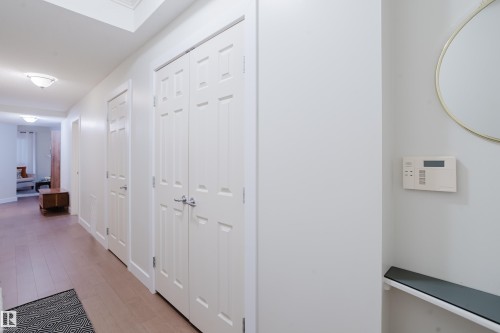 The property features light wood flooring, white paneled doors, and recessed lighting - 206 10108 125 Street, Edmonton, AB - Indoor Photo Showing Other Room