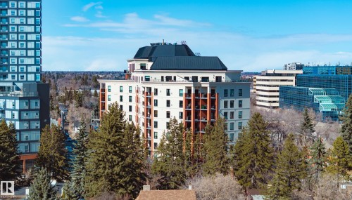 The property offers an elevated perspective of the surrounding cityscape and verdant trees - 206 10108 125 Street, Edmonton, AB - Outdoor