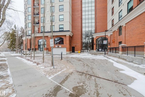 The property features an exterior with brick detailing, large arched windows, and a prominent glass facade - 206 10108 125 Street, Edmonton, AB - Outdoor