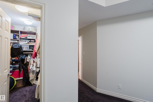 The property features a closet with built-in shelving, providing ample storage - 206 10108 125 Street, Edmonton, AB - Indoor Photo Showing Other Room