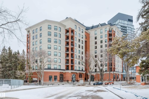The property features a brick and light-colored facade, with several balconies visible - 206 10108 125 Street, Edmonton, AB - Outdoor With Facade