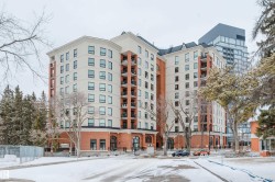 The property features a brick and light-colored facade, with several balconies visible - 