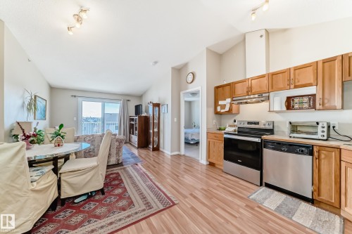 Open-concept layout with light wood flooring and track lighting - 324 9525 162 Avenue Nw, Edmonton, AB - Indoor Photo Showing Other Room