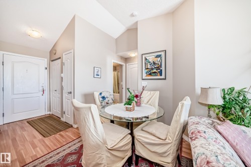 This inviting space features light-colored walls and a vaulted ceiling, providing an airy atmosphere - 324 9525 162 Avenue Nw, Edmonton, AB - Indoor Photo Showing Dining Room