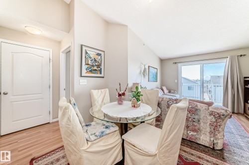 Open concept living area with vaulted ceilings, light-colored walls, and light-toned flooring - 324 9525 162 Avenue Nw, Edmonton, AB - Indoor Photo Showing Dining Room