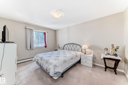 This room features light-colored walls and carpeted flooring, creating a neutral canvas - 324 9525 162 Avenue Nw, Edmonton, AB - Indoor Photo Showing Bedroom