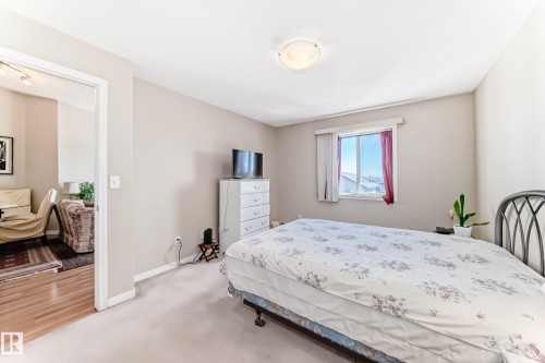 This room features a window providing natural light, neutral-toned walls, and carpeted flooring - 324 9525 162 Avenue Nw, Edmonton, AB - Indoor Photo Showing Bedroom