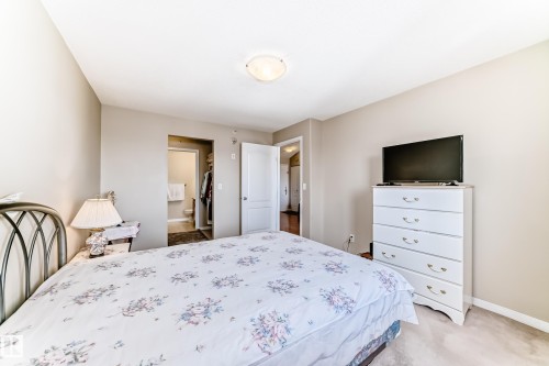 This property features a bedroom with light-colored walls, a ceiling light fixture, and carpeted floors - 324 9525 162 Avenue Nw, Edmonton, AB - Indoor Photo Showing Bedroom