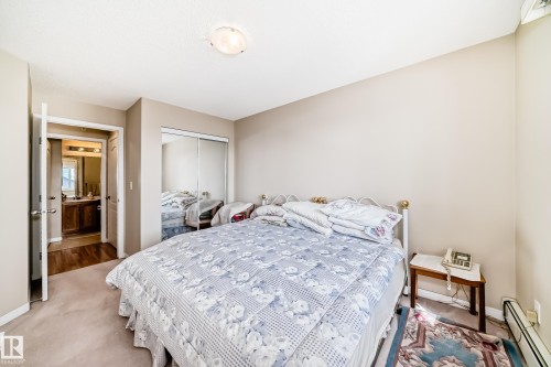 The property features a bedroom with neutral-toned walls and carpet flooring - 324 9525 162 Avenue Nw, Edmonton, AB - Indoor Photo Showing Bedroom