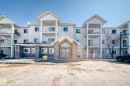 The property features a multi-story building with a stone facade on the ground level and light-colored siding on upper levels - 324 9525 162 Avenue Nw, Edmonton, AB  - Outdoor With Facade 
