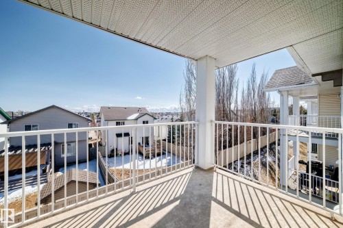 The property features a balcony with a white railing and a view of surrounding residences and trees - 324 9525 162 Avenue Nw, Edmonton, AB - Outdoor With Exterior