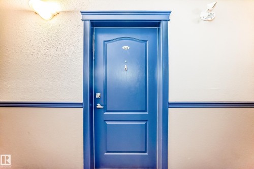 The property features a blue entry door with decorative trim - 324 9525 162 Avenue Nw, Edmonton, AB -  Photo Showing Other Room