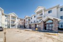 The property features a multi-story building with a stone facade entrance, white siding, and several private balconies - 324 9525 162 Avenue Nw, Edmonton, AB  - Outdoor With Facade 