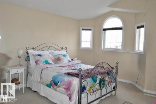 This room features light-colored walls and carpeted flooring - 16832 79 Street Nw, Edmonton, AB - Indoor Photo Showing Bedroom