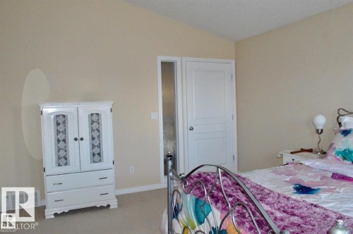 Well-lit room with neutral-toned walls and a vaulted ceiling - 16832 79 Street Nw, Edmonton, AB - Indoor Photo Showing Bedroom