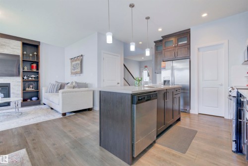 The property features an open-concept living area with light-colored flooring throughout - 8452 Cushing Crest, Edmonton, AB - Indoor Photo Showing Kitchen With Upgraded Kitchen