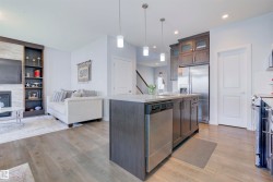 The property features an open-concept living area with light-colored flooring throughout - 