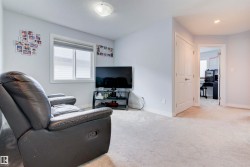 This area features light-colored carpeting, a window with blinds for natural light, and a white door - 