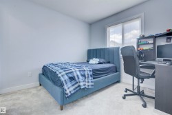 This room features a window with blinds, light-colored walls, and carpeting - 
