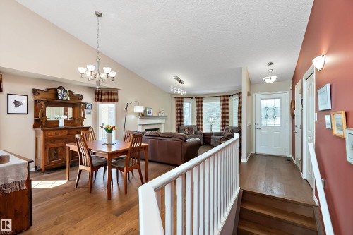 This property features vaulted ceilings, hardwood flooring, and a fireplace - 14 920 119 Street, Edmonton, AB - Indoor Photo Showing Dining Room