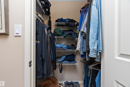 The property features a closet with wire shelving and hanging rods for ample storage - 14 920 119 Street, Edmonton, AB - Indoor With Storage