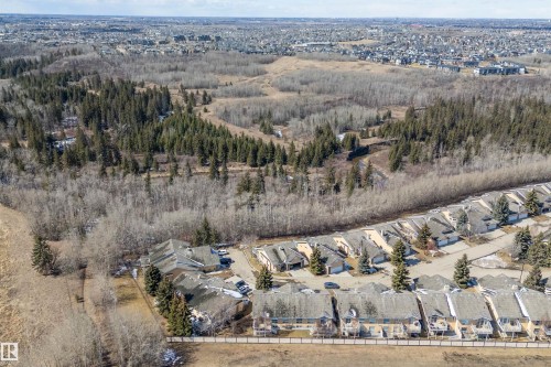 This aerial view showcases the property's proximity to extensive wooded areas, offering a serene natural backdrop - 14 920 119 Street, Edmonton, AB - Outdoor With View