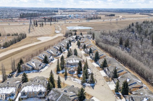 An aerial view showcasing the property's location within a residential area featuring detached homes with grey roofs - 14 920 119 Street, Edmonton, AB - Outdoor With View