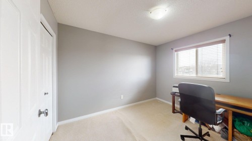 This room features neutral-toned walls, a window with blinds, and carpeted flooring - 5929 8 Avenue, Edmonton, AB - Indoor Photo Showing Office
