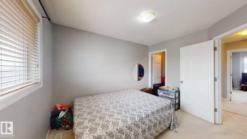 This room features light grey walls, carpeted flooring, and a window with blinds - 5929 8 Avenue, Edmonton, AB - Indoor Photo Showing Bedroom