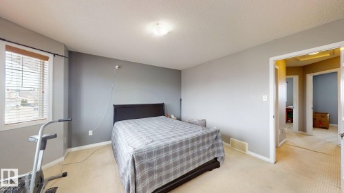 This room features carpeted flooring, light grey walls, and a window with blinds - 5929 8 Avenue, Edmonton, AB - Indoor Photo Showing Bedroom