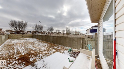 The property features a fenced yard with a combination of grass and snow cover - 5929 8 Avenue, Edmonton, AB - Outdoor