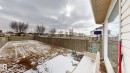 The property features a fenced yard with a combination of grass and snow cover - 5929 8 Avenue, Edmonton, AB  - Outdoor 
