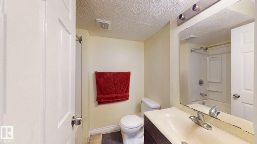 Bathroom featuring a vanity with a sink, a toilet, and a shower/tub combination - 5929 8 Avenue, Edmonton, AB - Indoor Photo Showing Bathroom