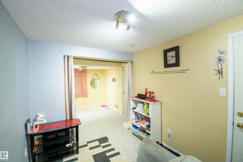 This room features light-colored walls and carpeted flooring - 2 9703 174 Street, Edmonton, AB - Indoor
