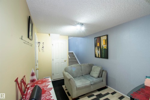 The property features a staircase with carpeted treads - 2 9703 174 Street, Edmonton, AB - Indoor