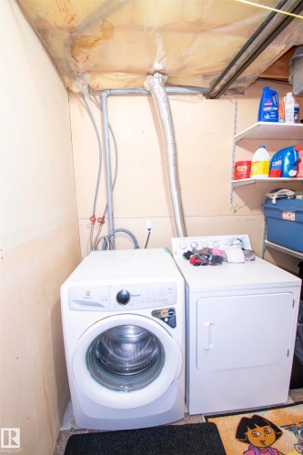 The property features a dedicated laundry area with a washer and dryer, providing convenience - 2 9703 174 Street, Edmonton, AB - Indoor Photo Showing Laundry Room