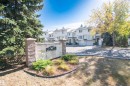 The property features a stone and concrete entrance sign, surrounded by landscaping with shrubs and groundcover - 2 9703 174 Street, Edmonton, AB  - Outdoor 