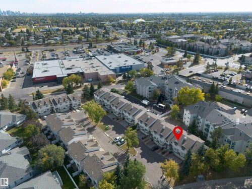 Aerial view of the property, located within a community featuring residential buildings and nearby commercial establishments - 2 9703 174 Street, Edmonton, AB - Outdoor With View