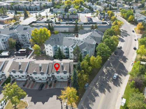 The property is situated within a development of townhomes, featuring a paved driveway and a well-maintained roof - 2 9703 174 Street, Edmonton, AB - Outdoor With View