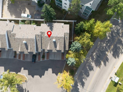 Aerial view of the property, featuring a gray shingle roof and proximity to a tree-lined street - 2 9703 174 Street, Edmonton, AB - Outdoor With View