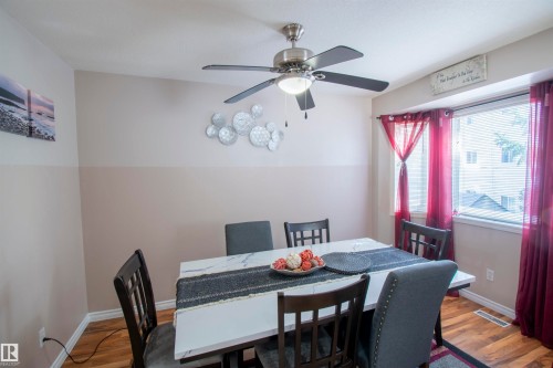 Dining area with wood flooring, a ceiling fan with integrated lighting, and a window providing natural light - 2 9703 174 Street, Edmonton, AB - Indoor Photo Showing Dining Room