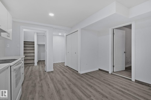 This versatile room features light-toned flooring, white walls, and recessed lighting - 12002 37 Street, Edmonton, AB - Indoor Photo Showing Kitchen