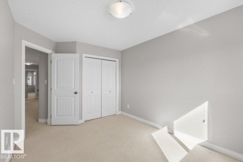 The room features light-colored walls and carpeted flooring - 16419 53 Street, Edmonton, AB - Indoor Photo Showing Other Room