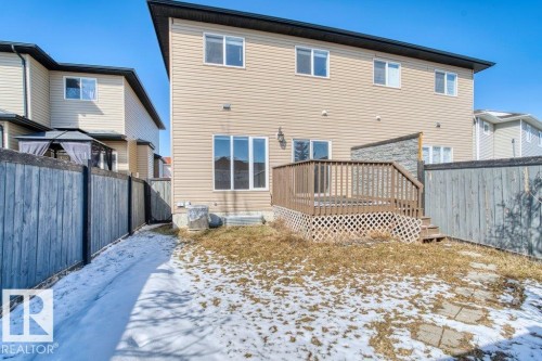 The property features a private backyard with a wooden deck, a privacy screen, and a partial fence - 16419 53 Street, Edmonton, AB - Outdoor With Deck Patio Veranda With Exterior