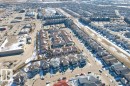 Aerial view showcasing the property situated within a developed residential area, featuring a mix of single-story and multi-story homes, and surrounded by commercial buildings and streets - 16419 53 Street, Edmonton, AB  - Outdoor With View 