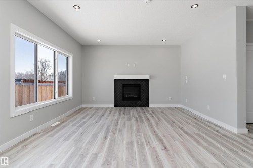 36 Maple Crescent, Gibbons, AB - Indoor Photo Showing Living Room With Fireplace