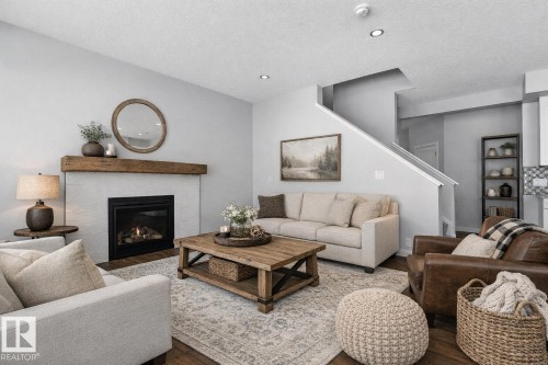 AI Photo - 72 Maple Crescent, Gibbons, AB - Indoor Photo Showing Living Room With Fireplace