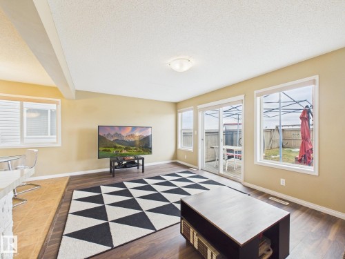 This living area features rich wood flooring and light-toned walls - 9073 Scott Crescent, Edmonton, AB - Indoor